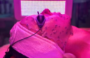 Pink LED light with woman with googles on